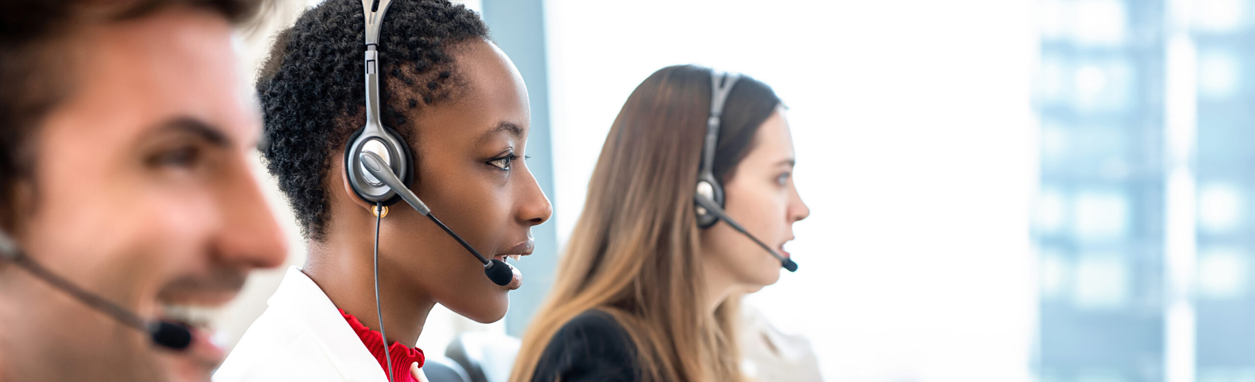 Contact centres agents on their headsets - close-up shot